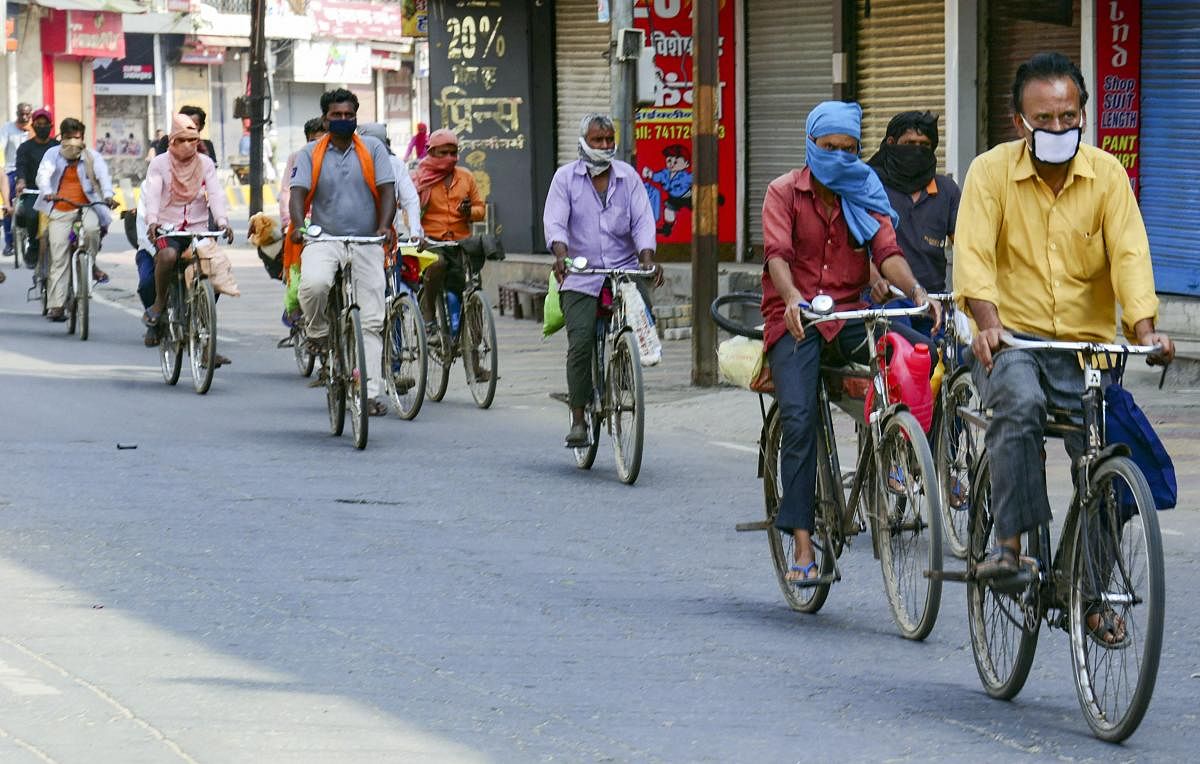 Some among 25 migrant workers who are cycling to their native place from Haryana amid COVID-19 lockdown, pass through Muzaffarnagar, Thursday, April 30, 2020. (PTI Photo)