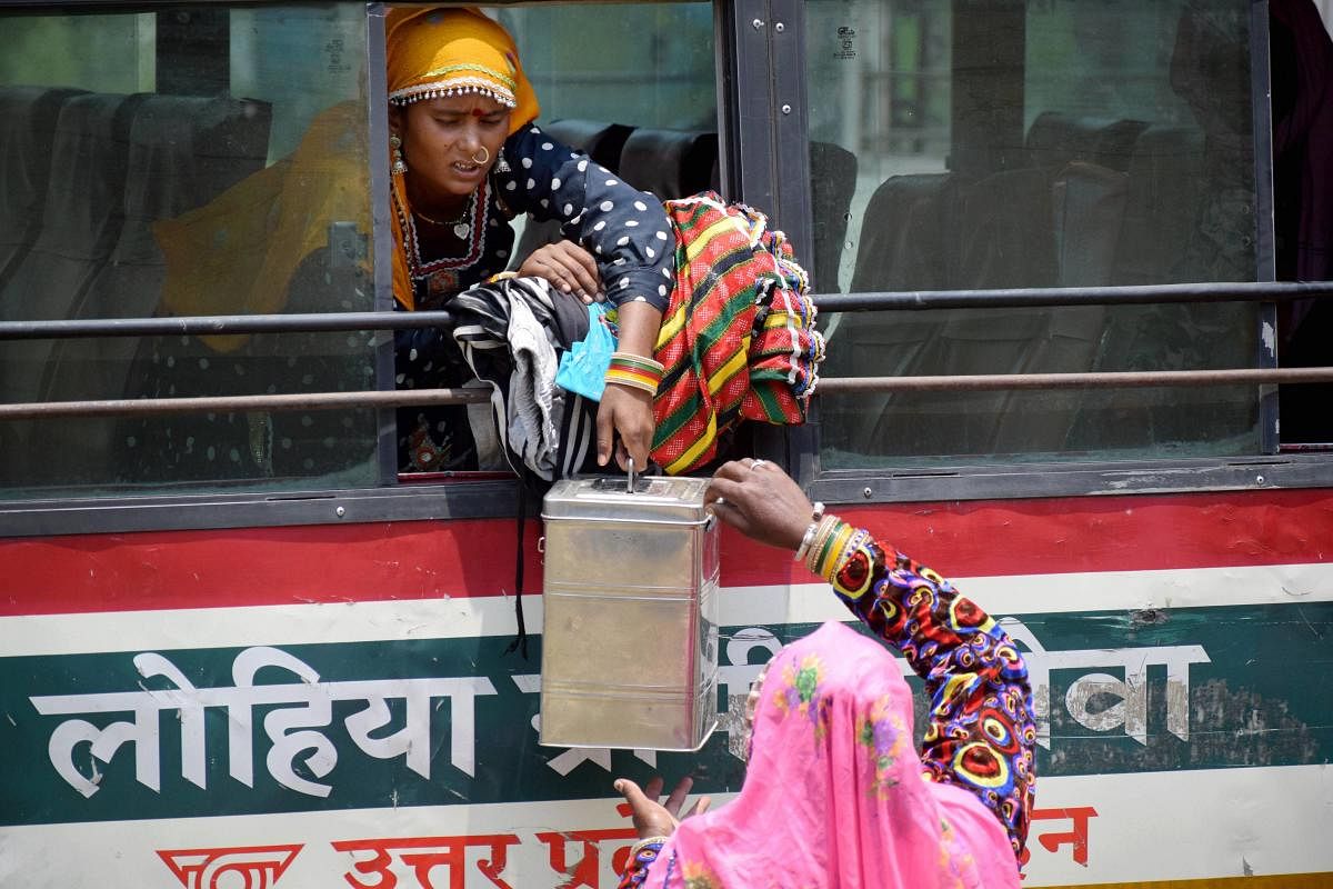 Migrant workers from Madhya Pradesh who were stranded in the city due to lockdown board a specially scheduled bus to reach their respective hometowns, in Prayagraj, Thursday, April 30, 2020. (PTI Photo)