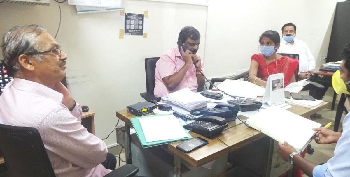 Officials take part in a phone-in programme conducted by the district administration in Kodagu.