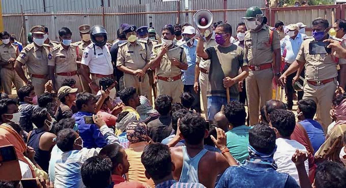  Police officials appeal to protesting migrant workers to maintain calm at IIT Hyderabad, Kandi, Wednesday, April 29, 2020. Peeved over denial of wages, hundreds of migrant workers working at IIT Hyderabad in neighbouring Sangareddy district today allegedly attacked some officials of construction companies and threw stones damaging a police vehicle and injuring a Sub-Inspector and two policemen. (PTI Photo)