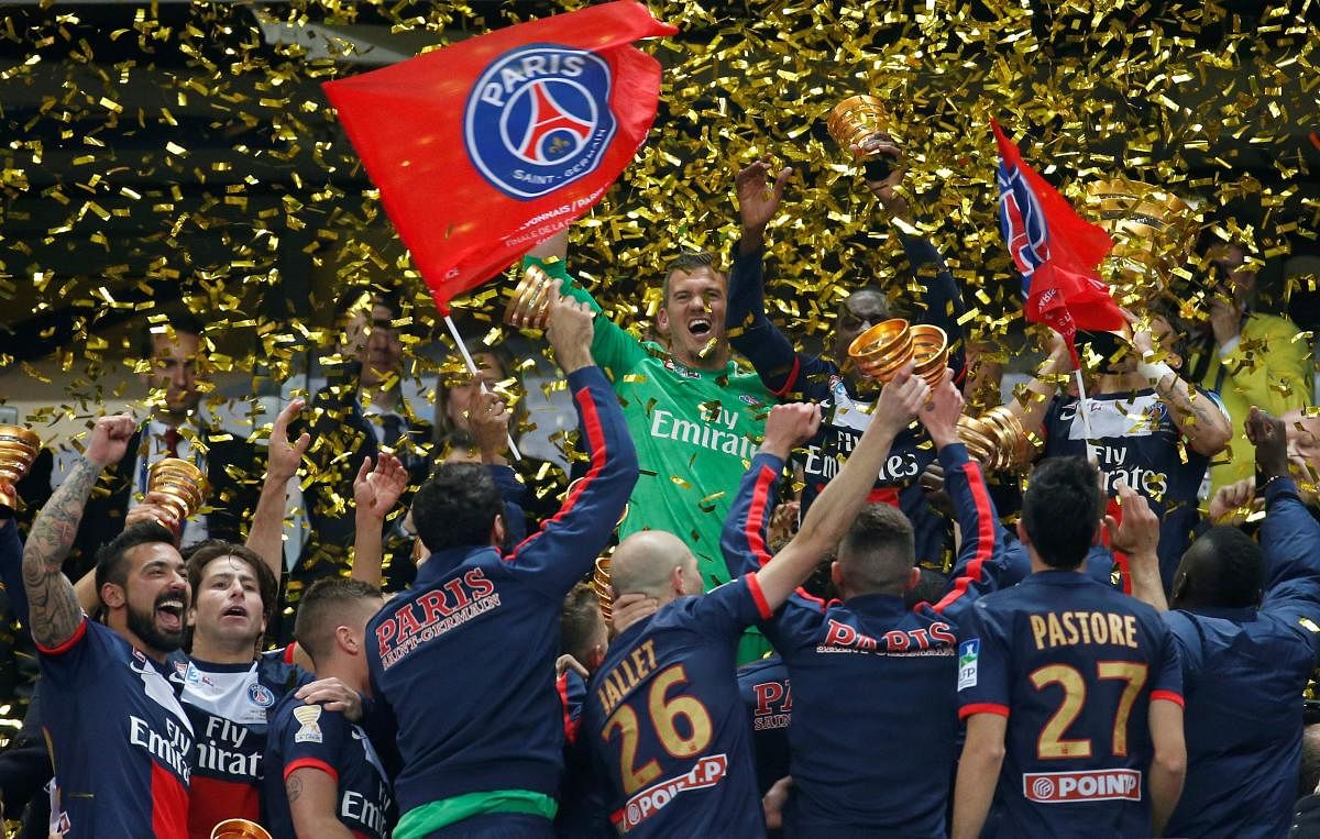 Paris St Germain's players celebrate with their trophy after defeating Olympique Lyonnais 2-1 in the French League Cup final at the Stade de France. Credit: Reuters File Photo