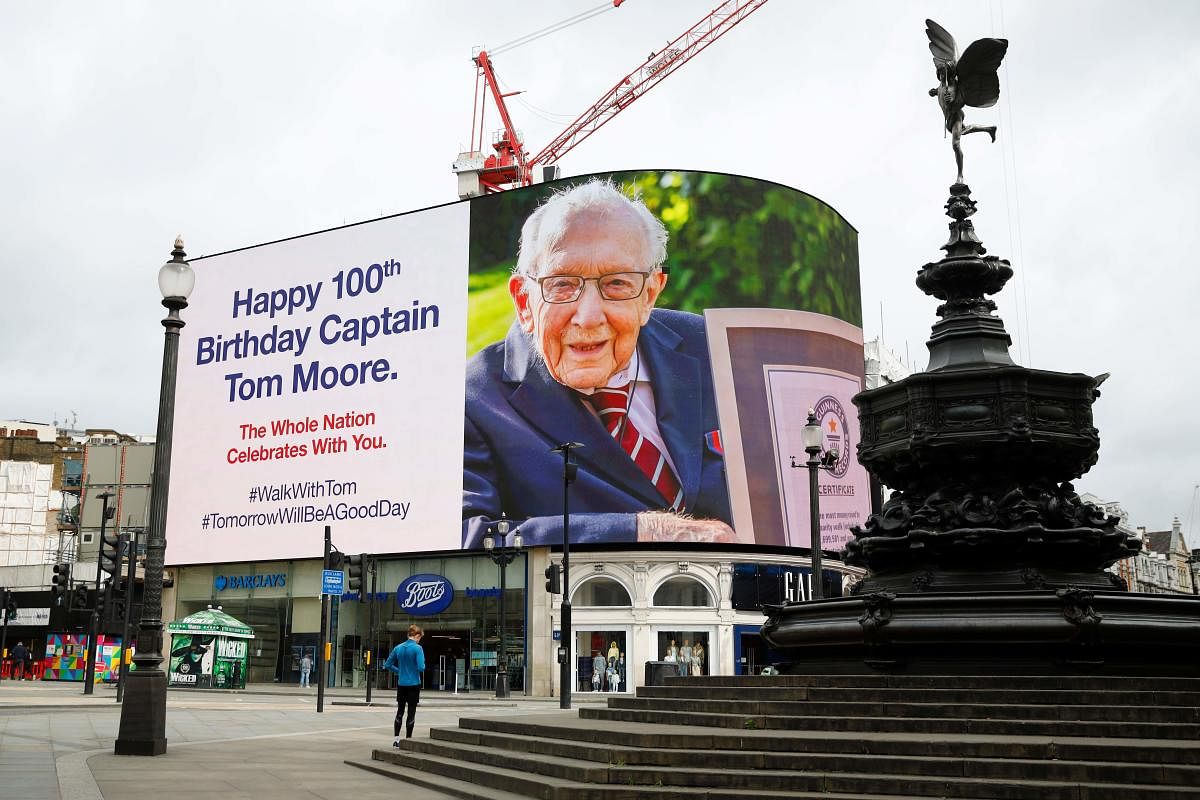 A birthday message for Captain Tom Moore is displayed on the advertising boards in Piccadilly Circus in London on April 30, 2020 as the country celebrates his 100th birthday.  Credit: AFP Photo