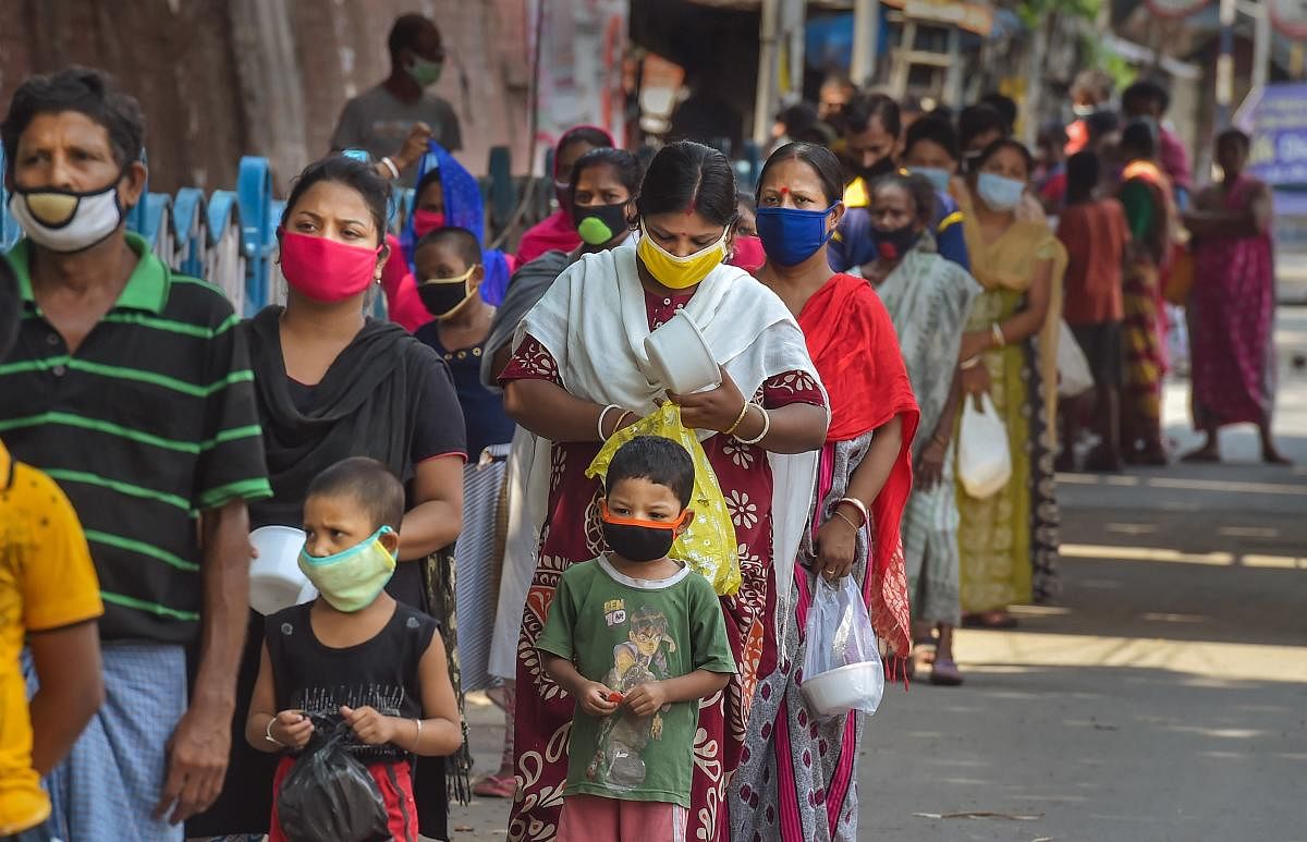 People wait in a long queue to collect food from volunteers during ongoing COVID-19 lockdown in Kolkata, Thursday, April 30, 2020. (PTI Photo)
