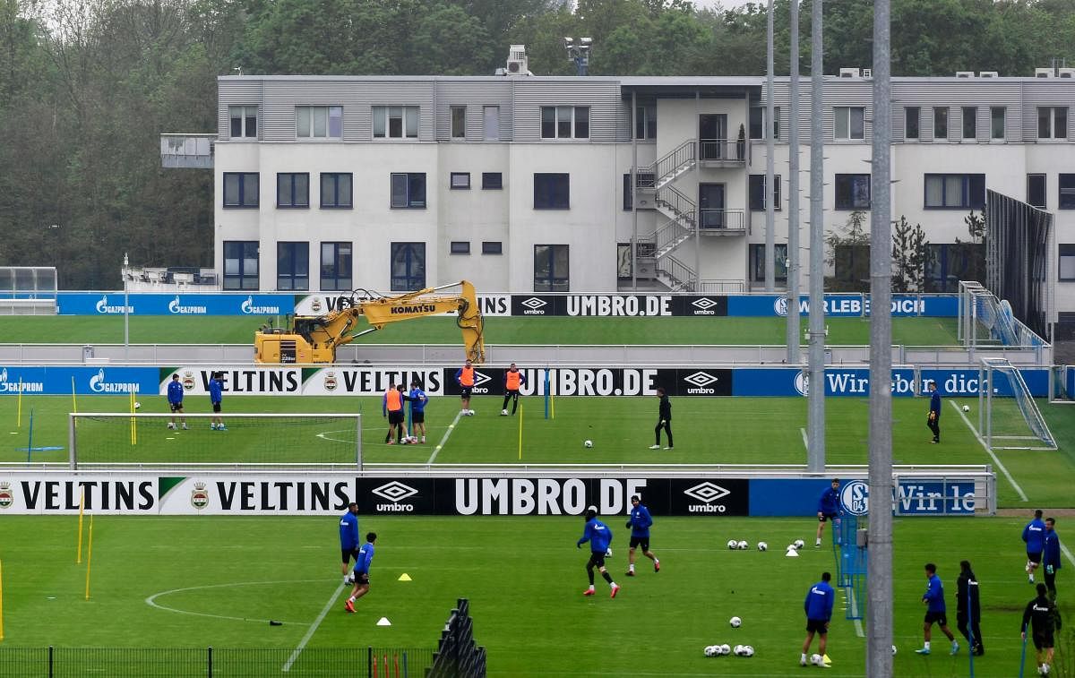 Bundesliga Club FC Schalke 04 train in small groups in Gelsenkirchen on Wednesday as some of the European football leagues look to resume play. AFP  
