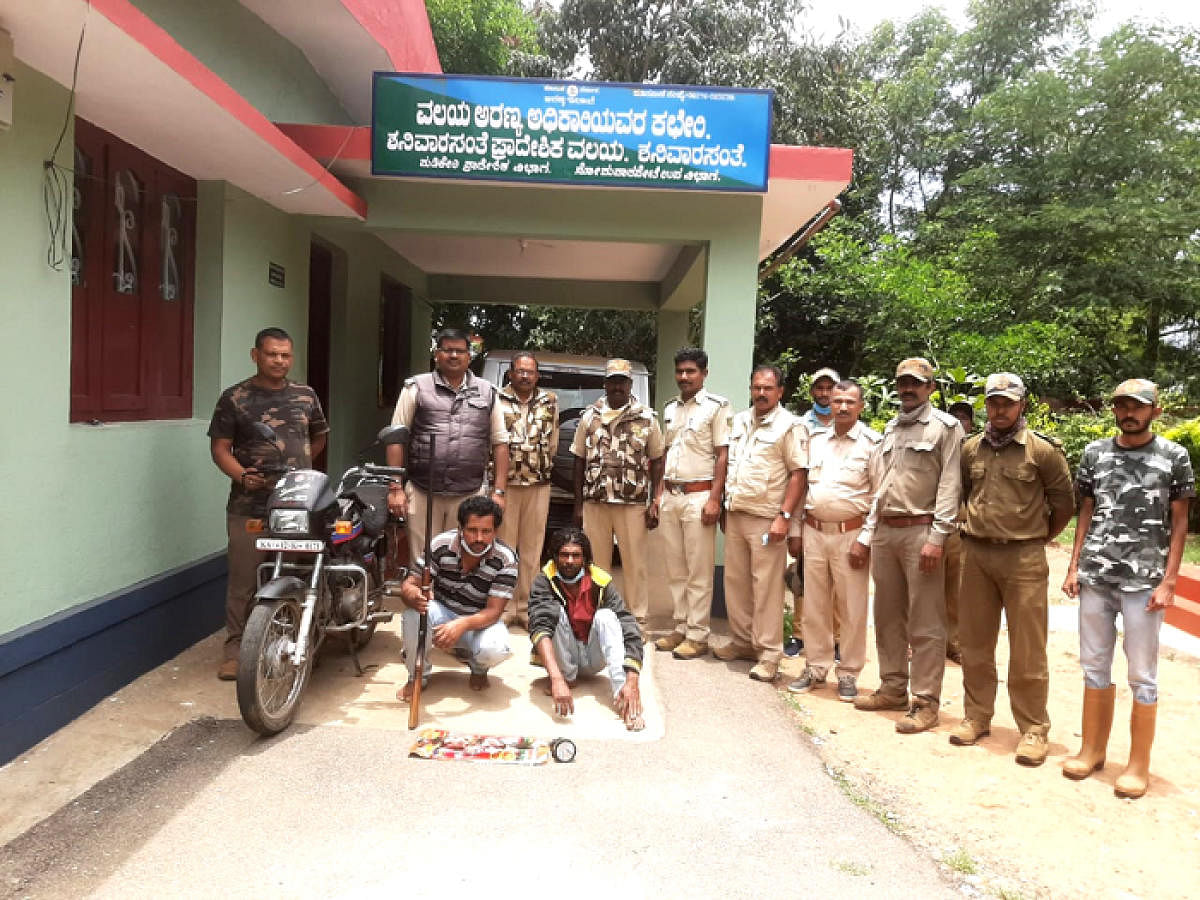 Forest Department personnel with the accused (sitting) and the seized items.