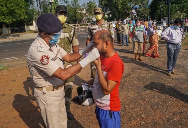 Representational Image--- Police helps put face mask on migrant worker (PTI File Photo)
