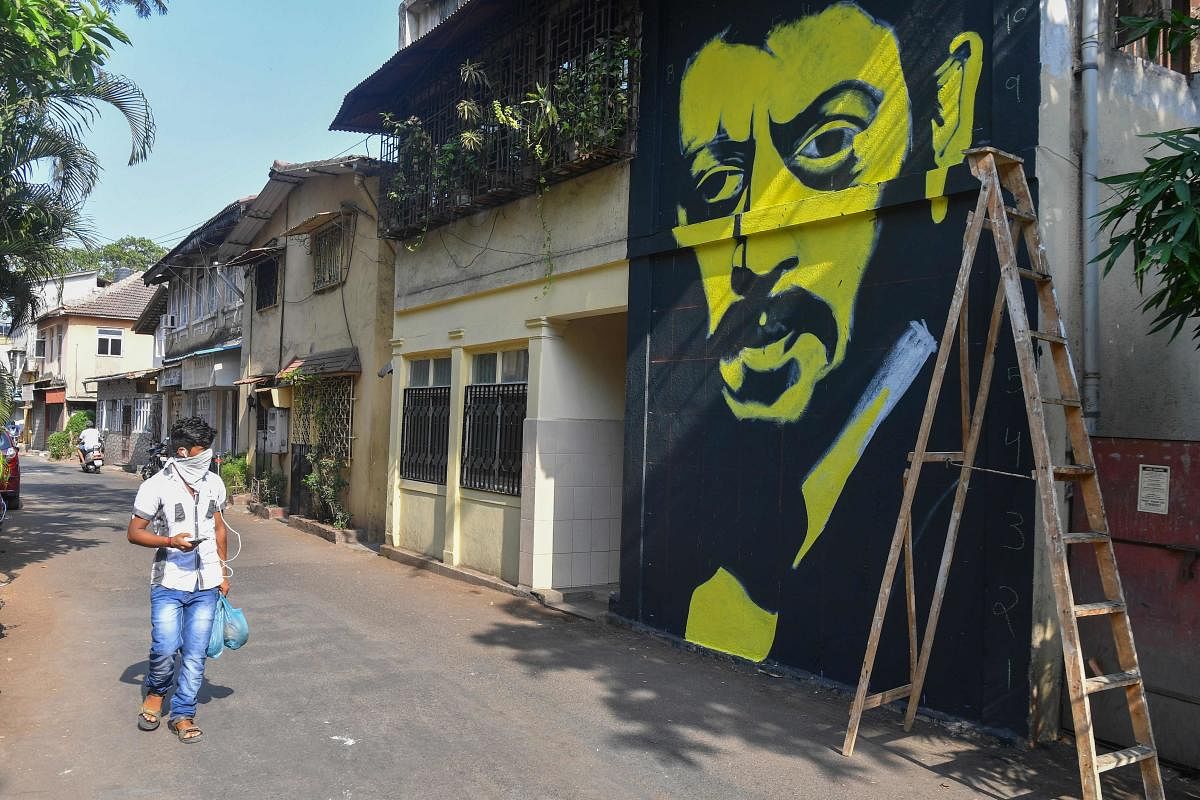A man walks past a wall mural of Bollywood actor Irrfan Khan in Mumbai. AFP