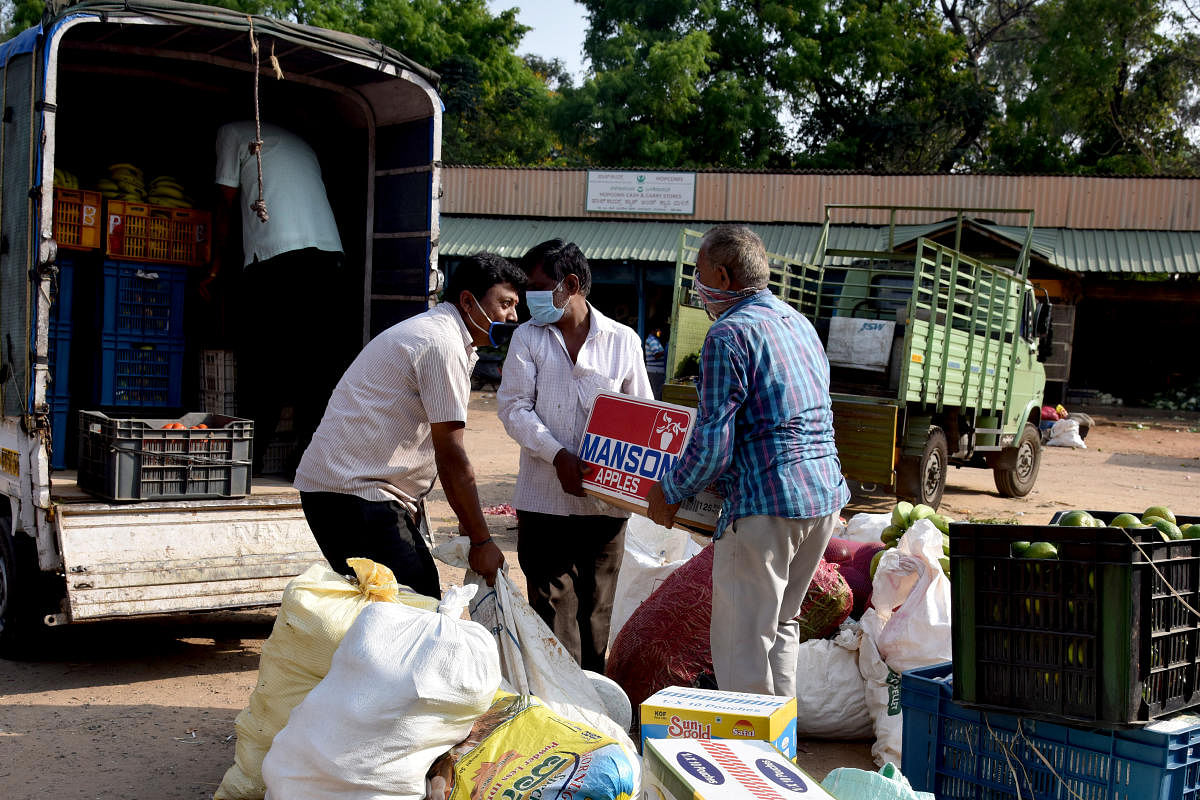 Workers loading vegetables, fruits to vans for sale at apartments around the city, at HOPCOMS Head Office, Lalbagh in Bengaluru on Sunday, 05 April 2020. HOPCOMS purchasing vegetables, fruits directly from farmers, during the caronavirus, Covid-19 lockdow