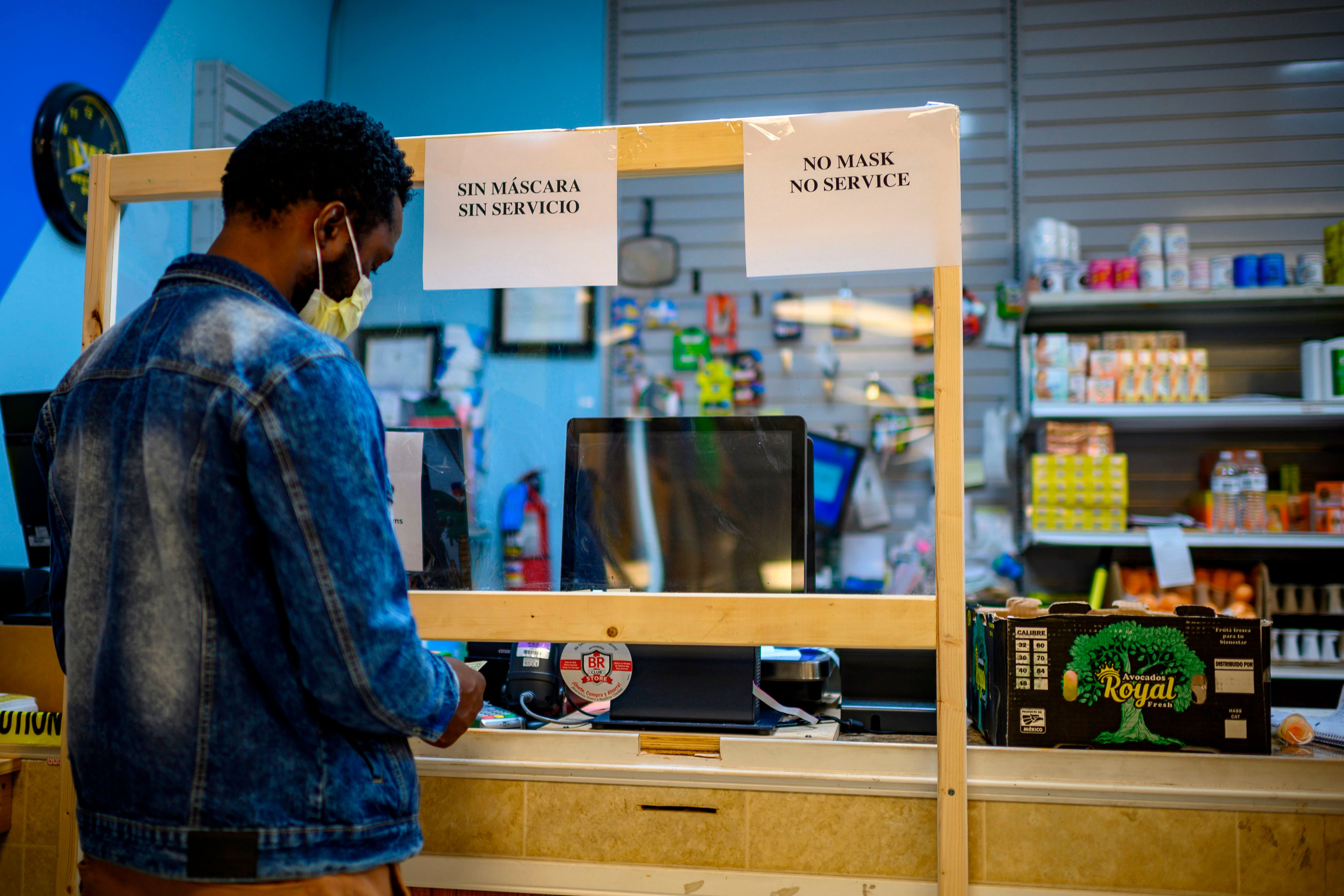 A man shops in a Haitian supermarket where members of the Haitian community are regular customers in Seaford, Delaware. (AFP Photo)