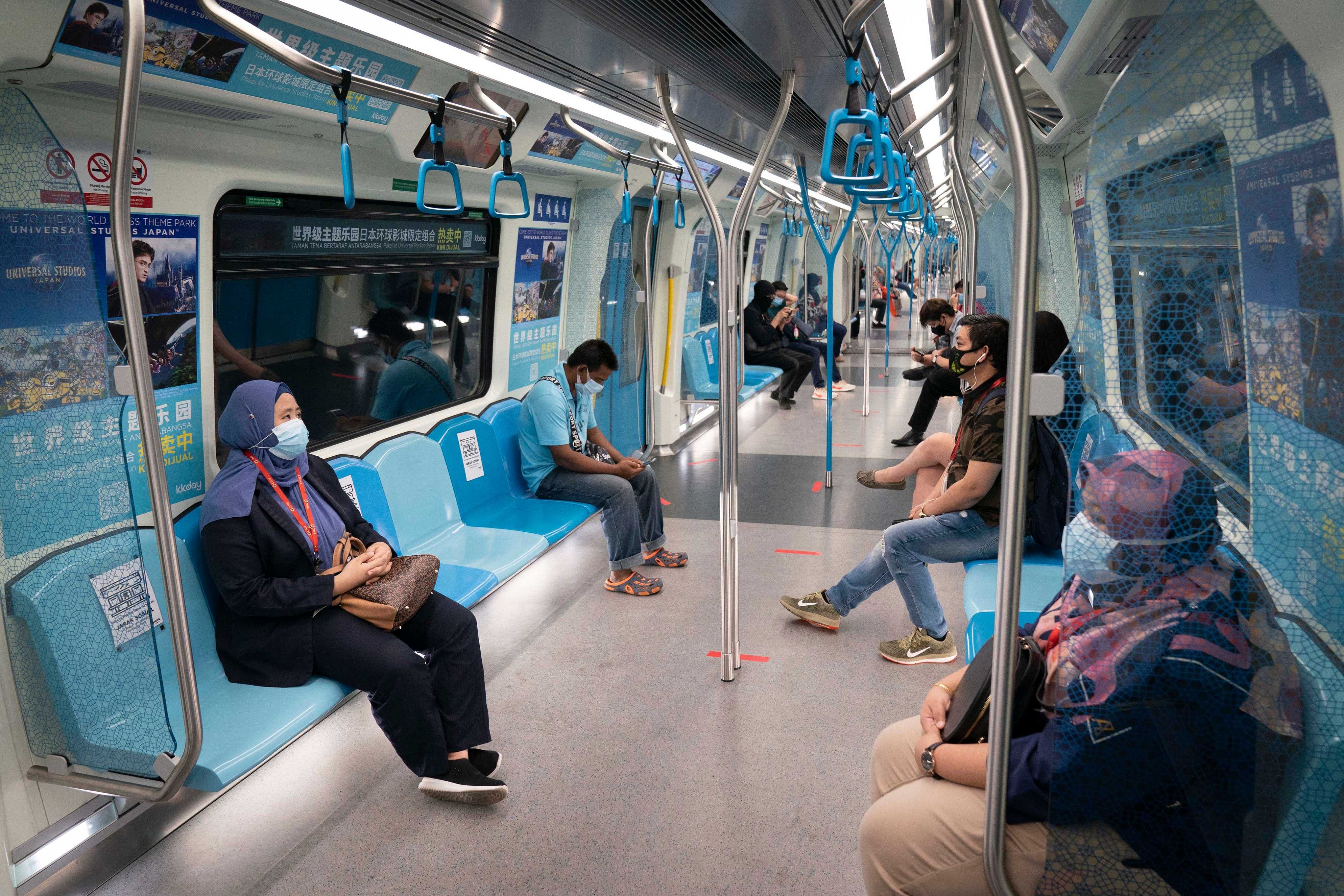 Commuters wear protective mask in a Mass Rapid Transit train, in Kuala Lumpur, Malaysia. (AP photo)