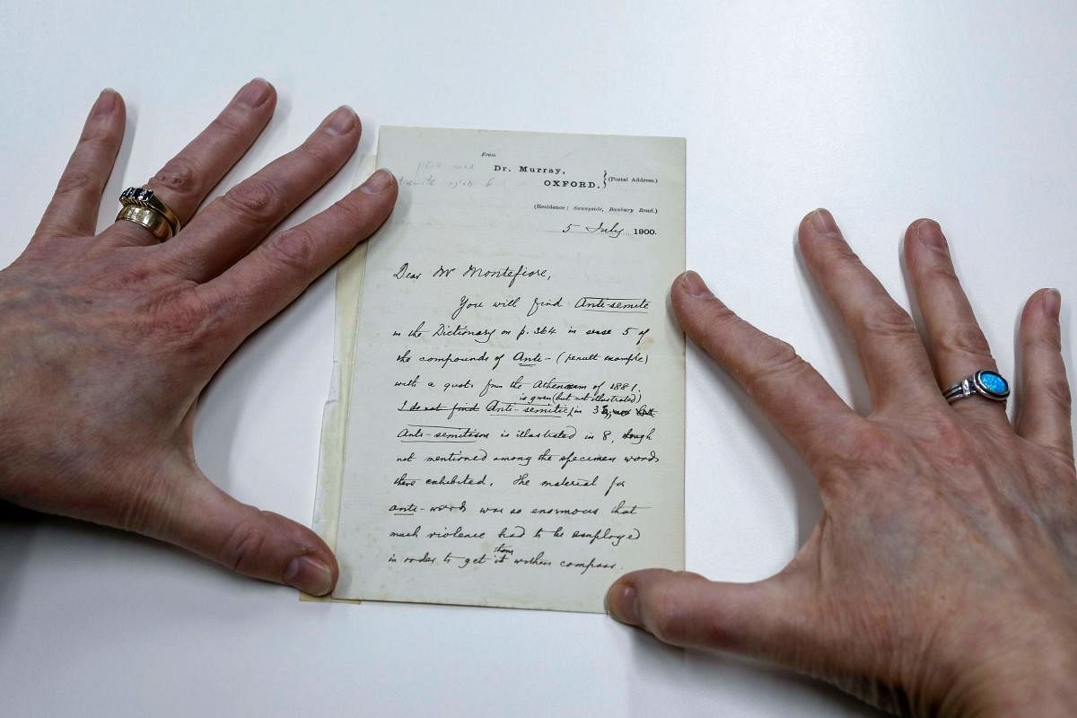 An archivist at the National Library of Israel displays a letter dated 1900 by Oxford English Dictionary editor James Murray, at the library premises in Jerusalem. AFP