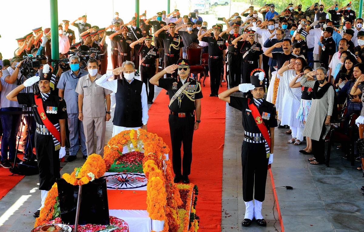 Rajasthan Chief Minister Ashok Ghelot (C), Lieutenant General Alok Singh Kler and others pay their last respects to the mortal remains of Col. Ashutosh Sharma, who was among five security personnel martyred during an encounter with militants in Handwara, in Jaipur, Tuesday, May 5, 2020. (PTI Photo)