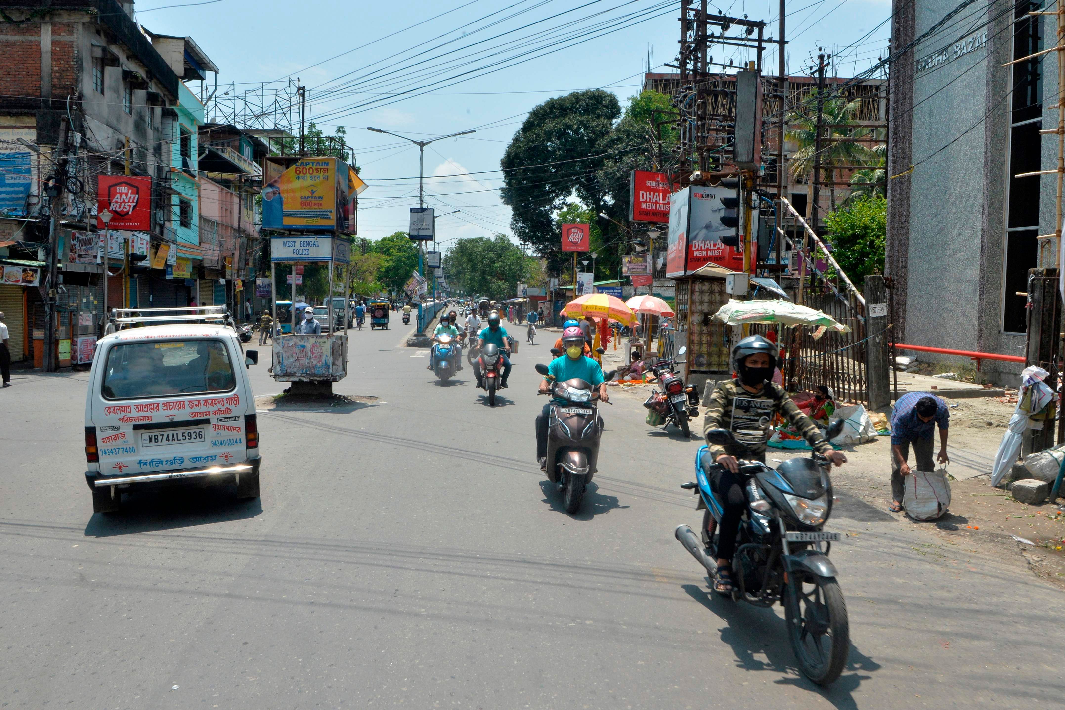 People are seen along a roads after the government eased a nationwide lockdown imposed as a preventive measure against the spread of the COVID-19 coronavirus, in Siliguri. (PTI Photo)