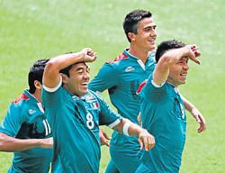 Mexicos Oribe Peralta (second from right) celebrates with team-mates after scoring against Brazil in the football final at the London Olympics on Saturday. AP