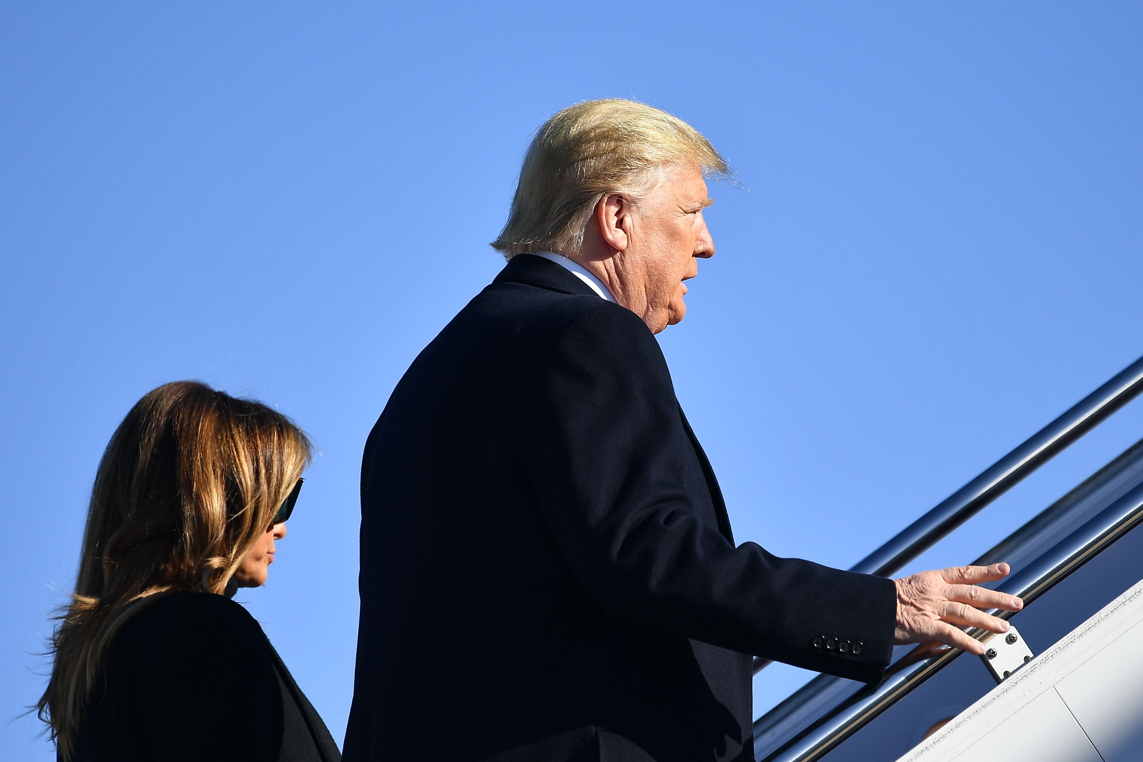 US President Donald Trump and First Lady Melania Trump make their way to board Air Force One before departing from Andrews Air Force Base in Maryland. (AFP Photo)