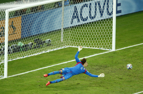 Mexico's goalkeeper Guillermo Ochoa dives to stop the ball during their 2014 World Cup Group A soccer match against Brazil at the Castelao arena in Fortaleza. Reuters photo