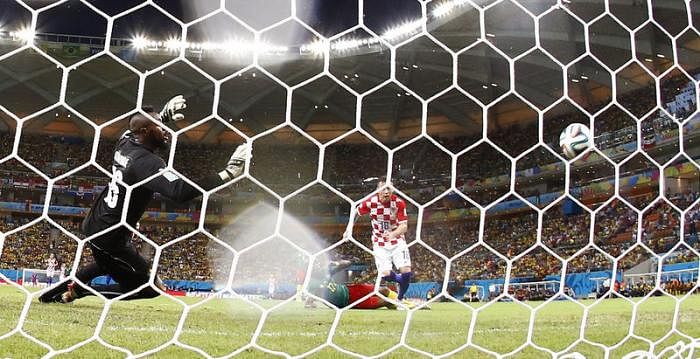 Croatia's Ivica Olic scores a goal past Cameroon's goalkeeper Charles Itandje