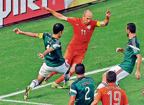 Catch me, I'll fall: The Netherlands' Arjen Robben (11) is challenged by Mexico's Rafael Marquez (left) during their pre-quarterfinal game at Fortaleza on Sunday. Robben took a tumble, leading to a penalty that was converted by Klaas-Jan Huntelaar to hand a 2-1 victory for the Netherlands. ap