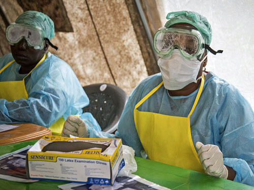Health workers wearing protective clothing and equipment against the deadly Ebola virus sit at the Kenema Government Hospital situated in the Eastern Province around 300 km, (186 miles) from the capital city of Freetown in Kenema, Sierra Leone. There is no panic movement out of West Africa by Indian nationals living in the region following the spread of the Ebola virus disease, officials of the Indian missions in Nigeria and Ghana have confirmed. AP photo