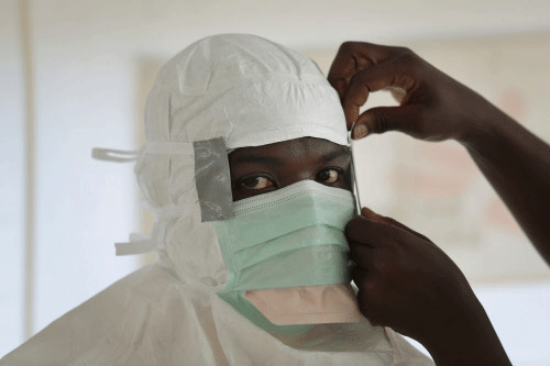 FILE - In this Sept. 29, 2014, file photo a MSF (Medecins Sans Frontieres) nurse gets prepared with Personal Protection Equipment before entering a high risk zone of MSF's Ebola isolation and treatment center in Monrovia, Liberia. (AP)