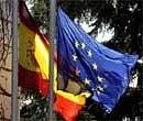 The Spanish flag and the European Union flag fly in front of the Moncloa palace in Madrid on Friday during a meeting of European officials.  AFP