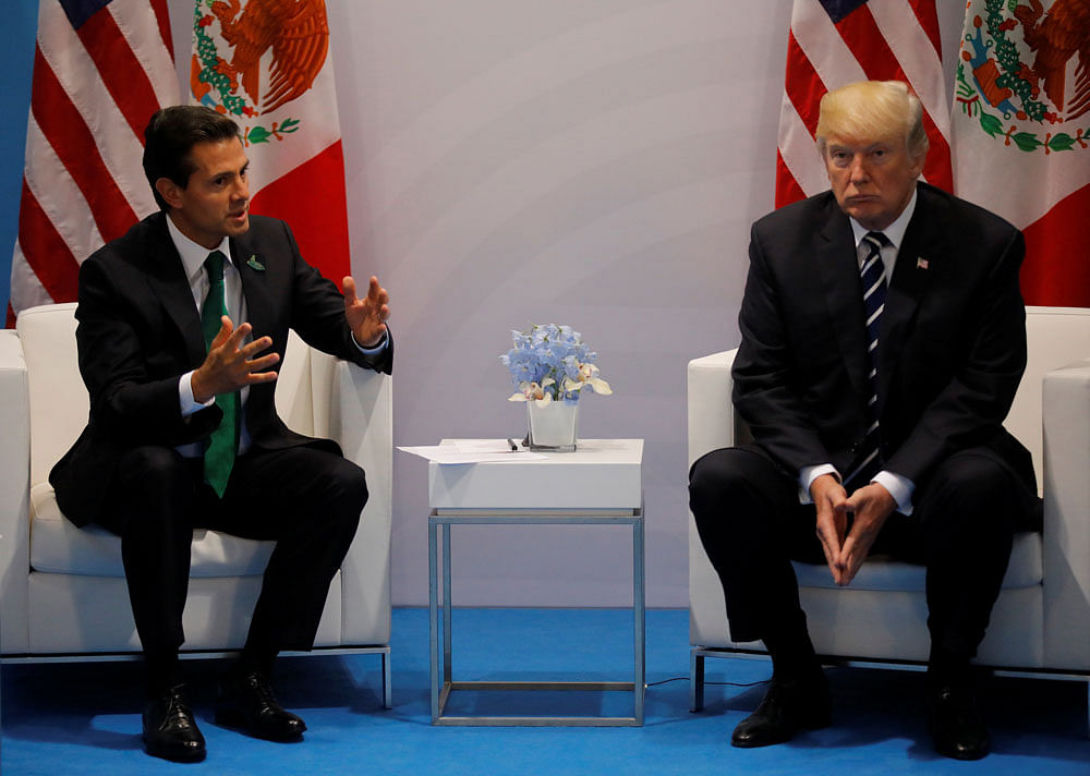 Trump, still insisting on making Mexico pay for the border wall, met Mexican president Pena Nieto at the G20 today. Photo credit: reuters.