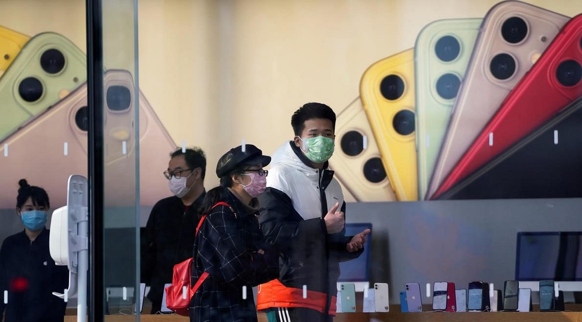 People wearing protective masks are seen in an Apple Store, as China is hit by an outbreak of the new coronavirus, in Shanghai (Credit: REUTERS/Aly Song)