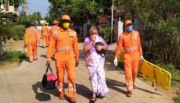 NDRF personnel evacuate an elderly woman after a major chemical gas leakage at LG Polymers industry in RR Venkatapuram village, Visakhapatnam. (PTI Photo) 