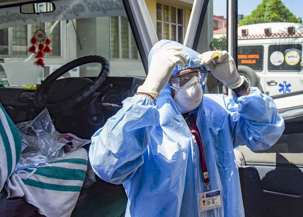 An ambulance driver, wearing protective suits, prepares to exit the Special Isolation Ward with novel coronavirus patients at Kochi Medical college, in Kerala, Tuesday, Feb. 4, 2020. Credit: PTI Photo