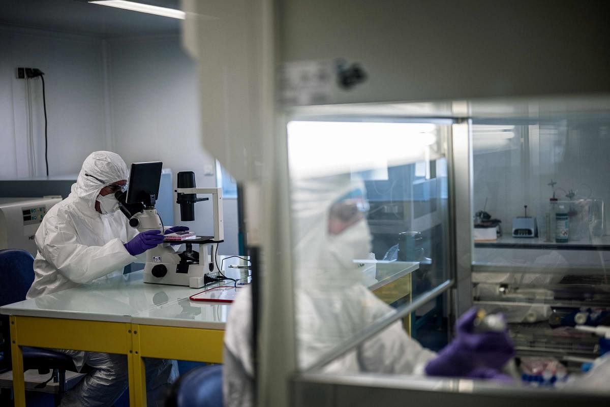 Scientists are at work in the VirPath university laboratory, classified as "P3" level of safety, on February 5, 2020 as they try to find an effective treatment against the new SARS-like coronavirus. (AFP Photo)