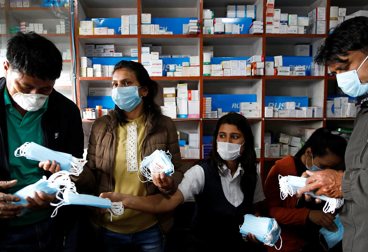 Employees sell face masks at a drug store as people gather to buy them amid concerns about the spread of coronavirus disease (COVID-19) outbreak, in Kathmandu(Reuters Photo)