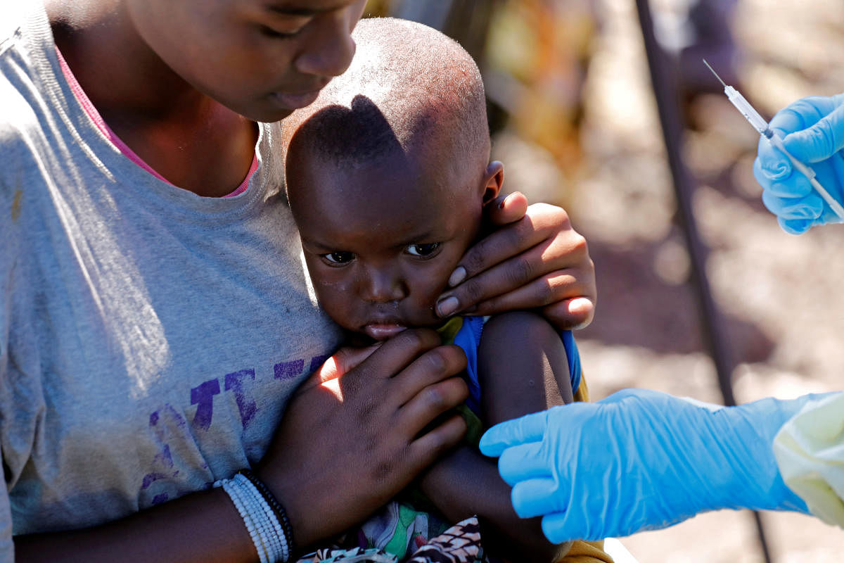  A child reacts as a health worker injects her with the Ebola vaccine, in Goma, Democratic Republic of Congo, August 5, 2019. REUTERS/Baz Ratner/File Photo