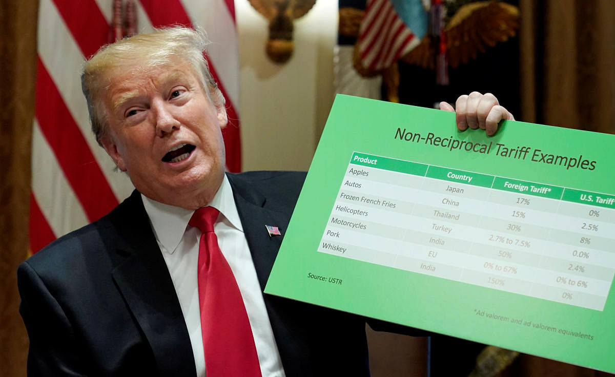 U.S. President Donald Trump holds up a chart on "non-reciprocal tariff examples" while speaking in the Cabinet Room of the White House in Washington. Reuters.