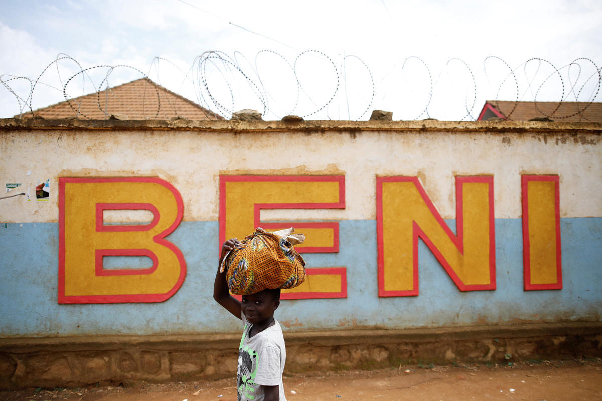 A Congolese boy walks past a wall near the Alima Ebola treatment centre in Beni, in the Democratic Republic of Congo. Reuters file photo.