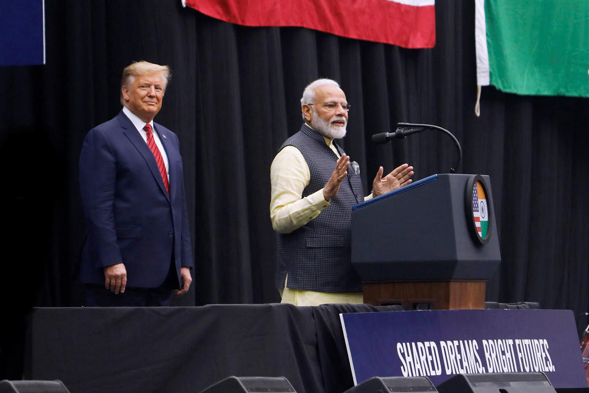 U.S. President Donald Trump looks on as Indian Prime Minister Narendra Modi speaks during a "Howdy, Modi" rally at NRG Stadium in Houston. (Reuters Photo)