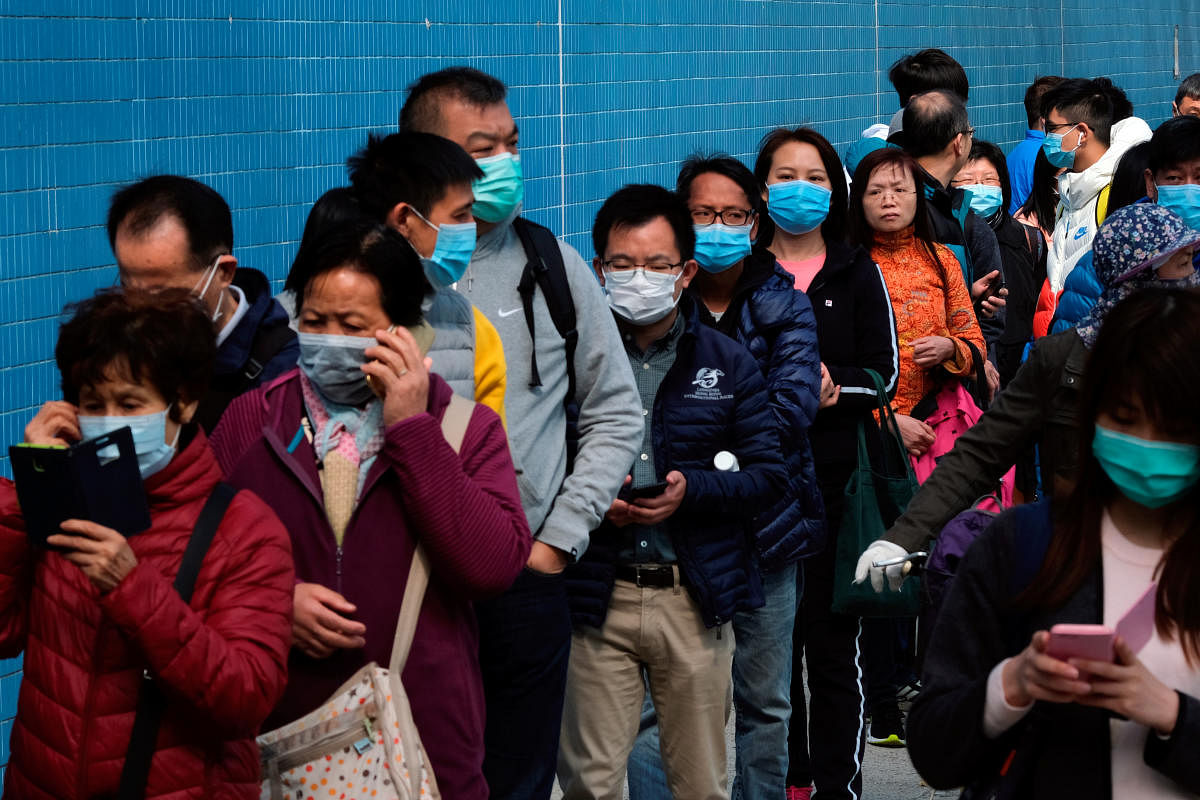 Customers queue to buy facial masks to prevent an outbreak of a new coronavirus, in Hong Kong, China January 28, 2020. (Reuters Photo)