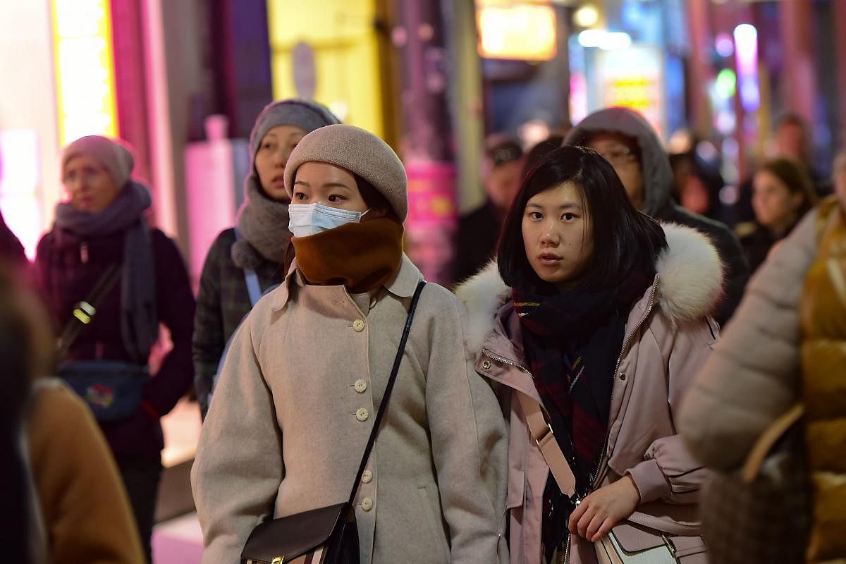 An Asian tourist wearing a protective mask as she walks in Istiklal street in Istanbul , on January 31, 2020. (AFP Photo)