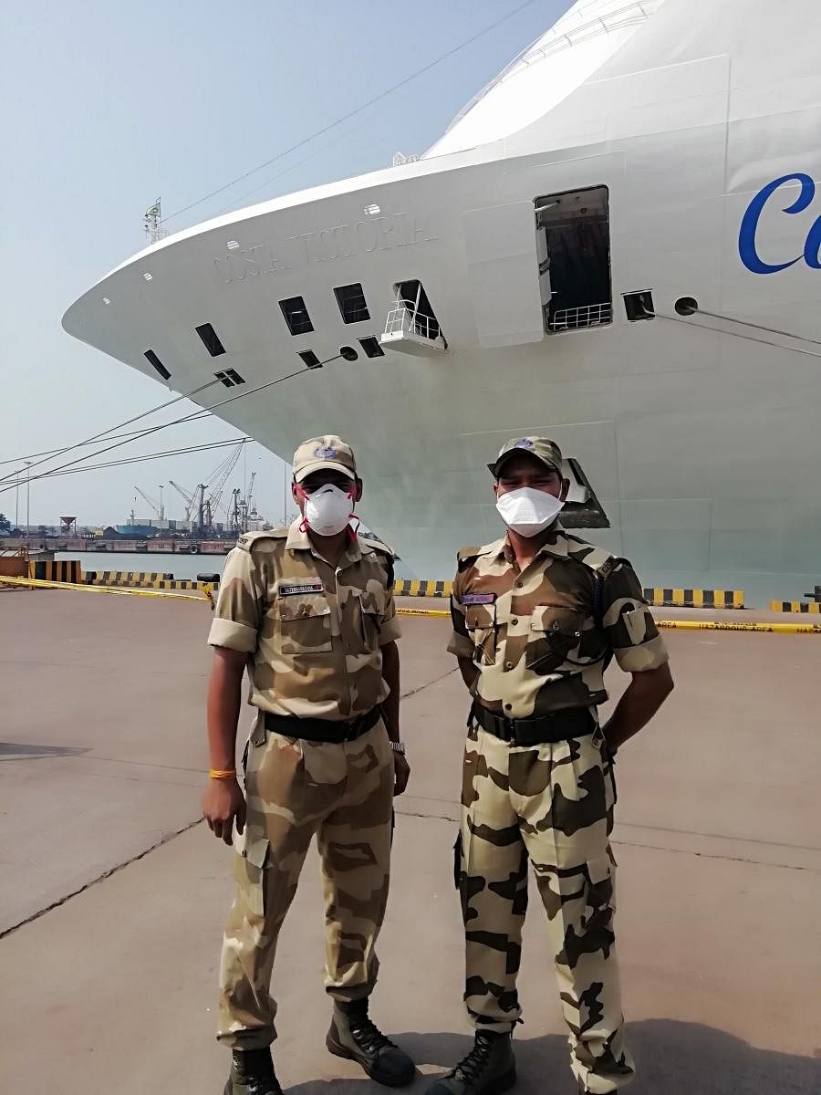 Personnel wear masks as a precautionary measure after a cruise vessel called at New Mangalore Port on Tuesday.