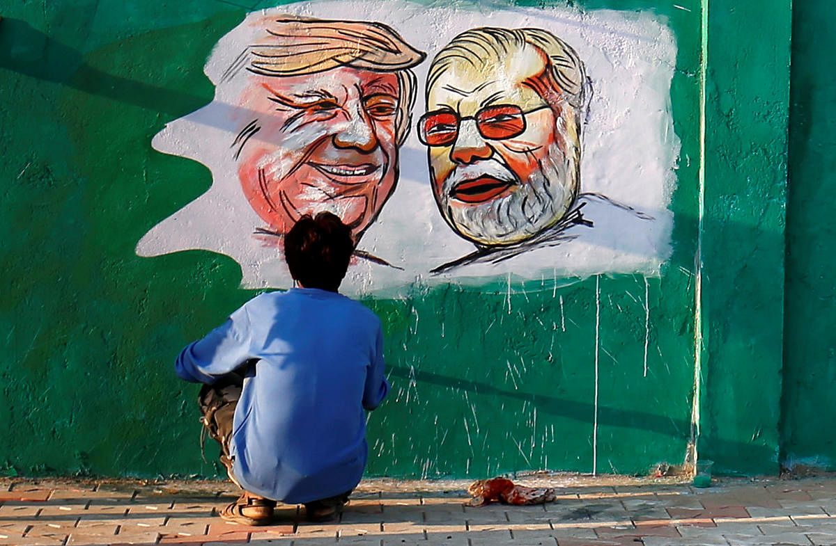 Paintings of U.S. President Donald Trump and India's Prime Minister Narendra Modi on a wall as part of a beautification along a route that Trump and Modi will be taking during Trump's upcoming visit, in Ahmedabad, India. (REUTERS Photo)