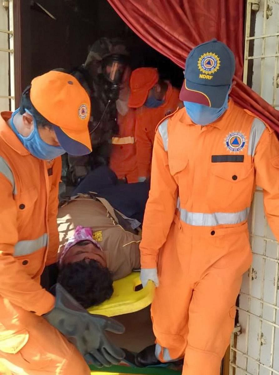 NDRF personnel evacuate an unconscious man after a major chemical gas leakage at LG Polymers industry in RR Venkatapuram village, Visakhapatnam. (PTI Photo)