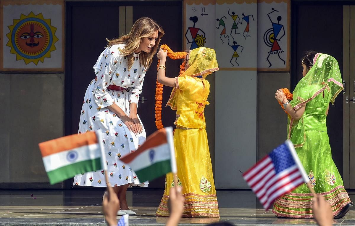 US first lady Melania Trump is garlanded by two children at Sarvodaya Co-Educational Senior Secondary School in New Delhi. (PTI Photo)