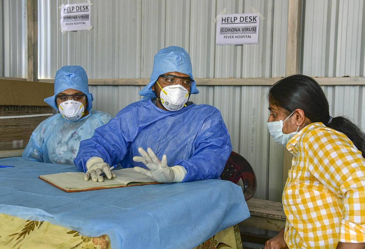 An Indian woman who recently returned from the United States being examined by doctors at a novel coronavirus help desk, at a hospital in Hyderabad, Tuesday, March 3, 2020. (PTI Photo)