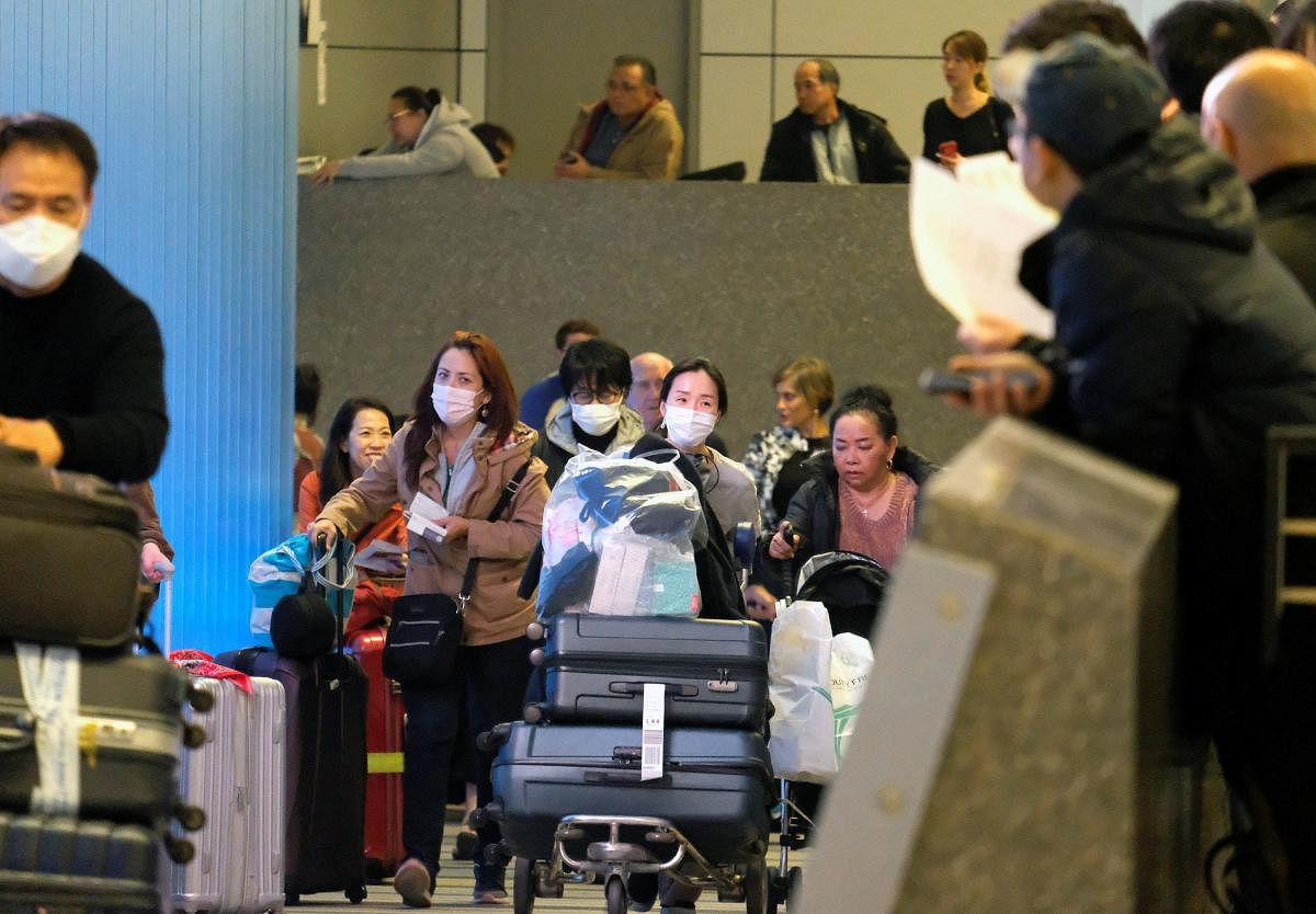 Passengers arrive at LAX from Shanghai, China, after a positive case of the coronavirus was announced in the Orange County suburb of Los Angeles, California, U.S., January 26, 2020. Credit: Reuters Photo