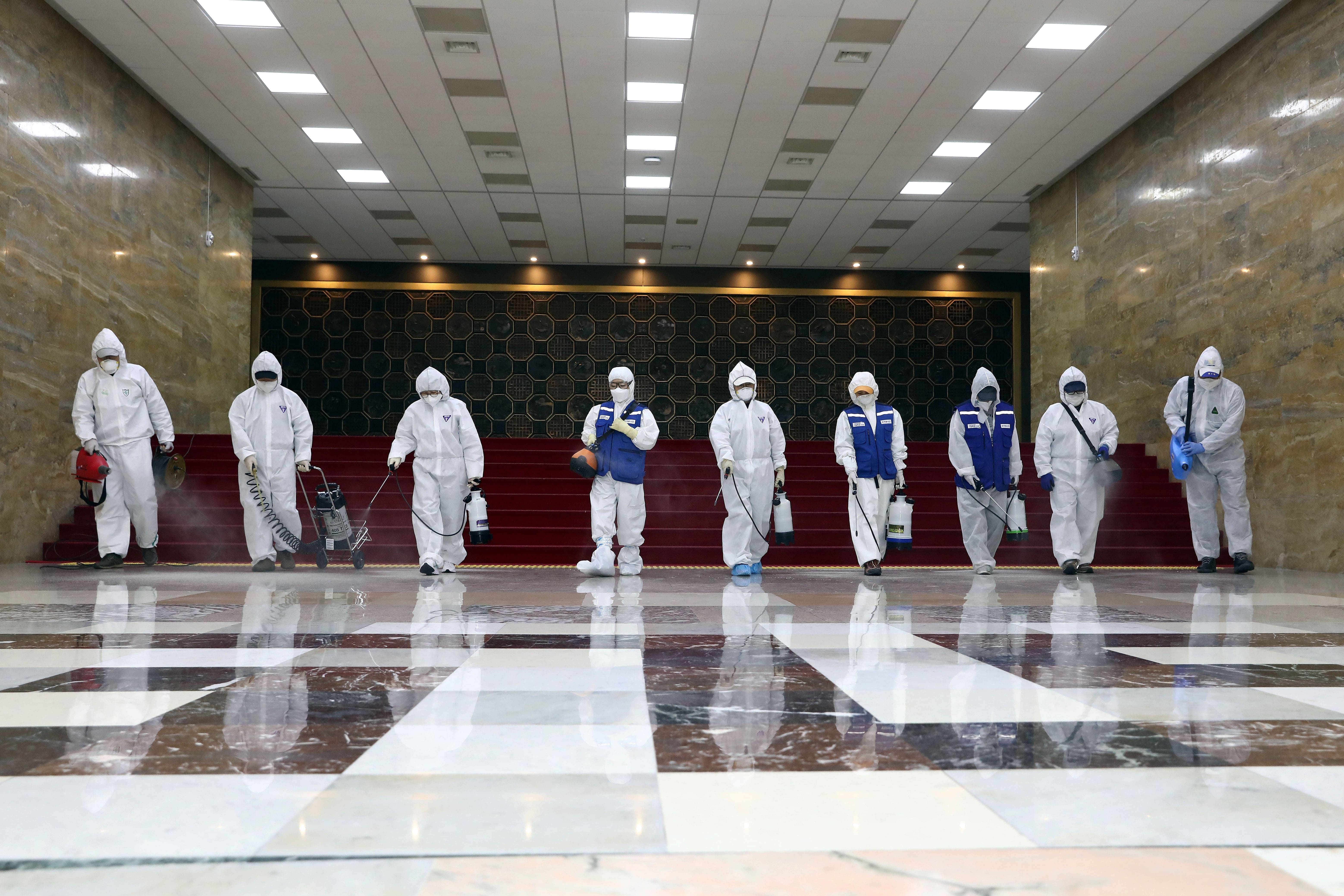 Employees from a disinfection service company sanitize the National Assembly in Seoul, South Korea. (Credit: Reuters Photo)