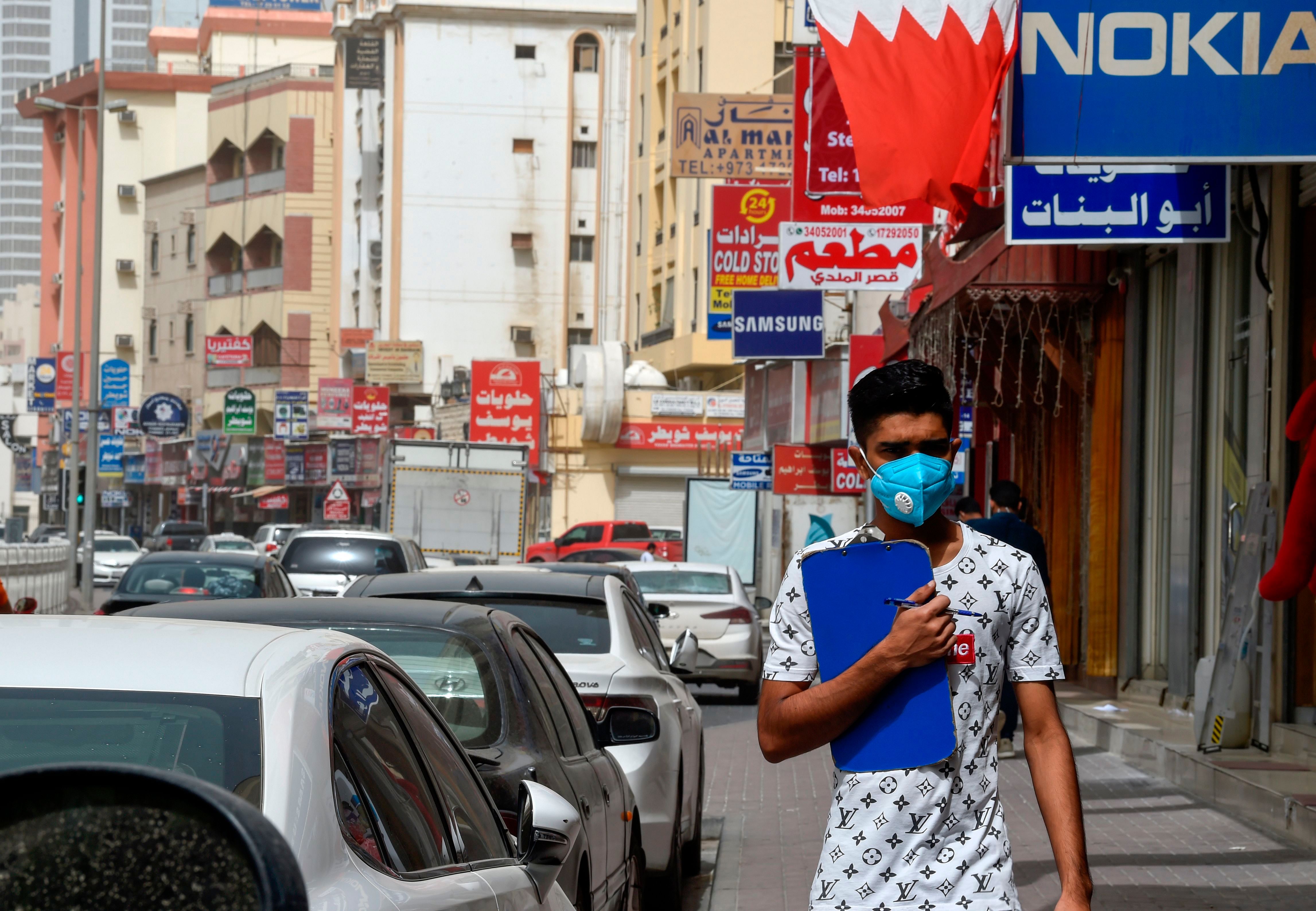 A man wearing a surgical mask is pictured in the heart of the Bahraini capital Manama. (AFP Photo)
