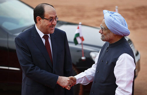 Prime Minister Manmohan Singh shakes hands with his Iraqi counterpart Nouri al-Maliki prior to a meeting in New Delhi on Friday. AP photo
