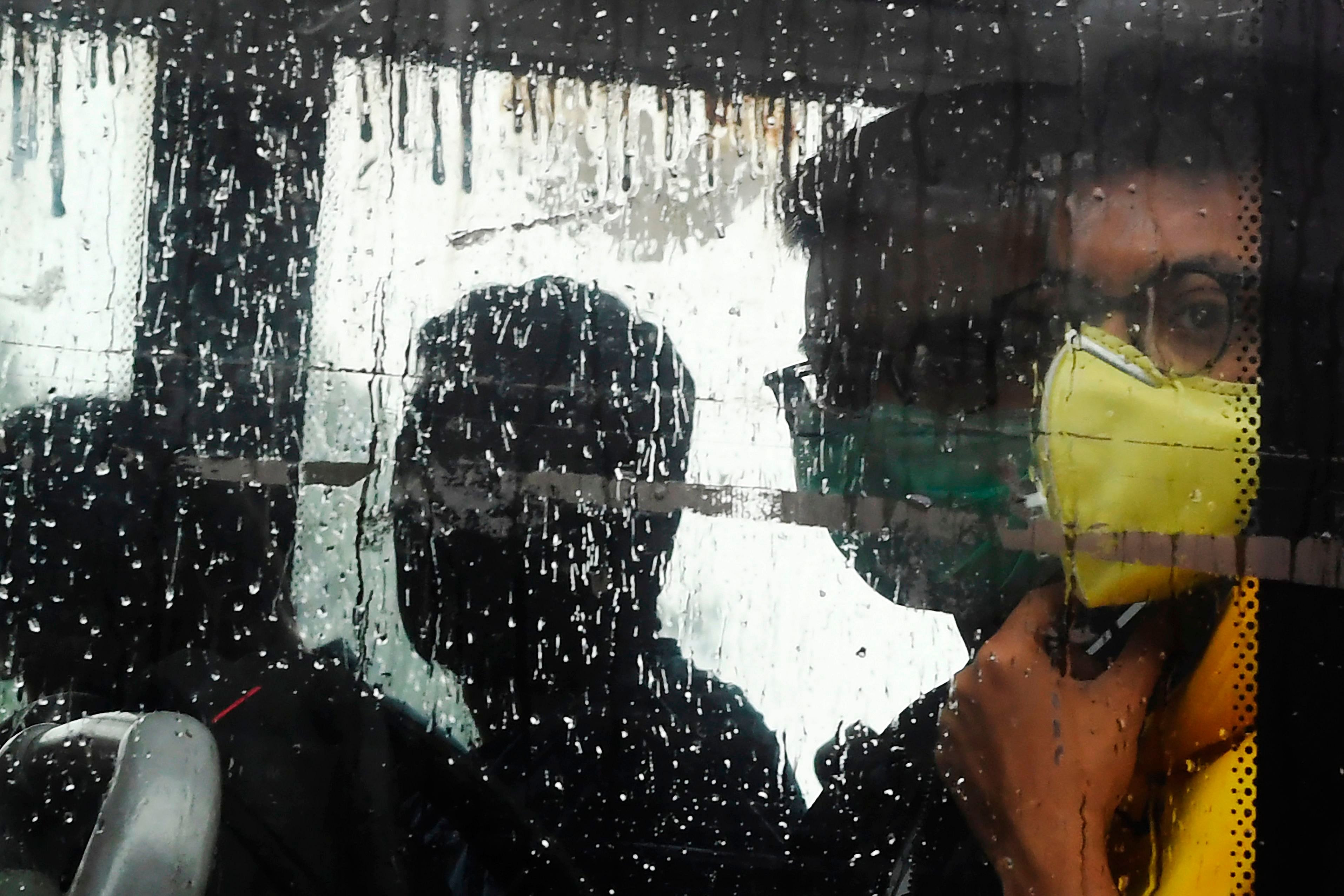 People are seen with masks in Kolkata. (Credit: AFP)
