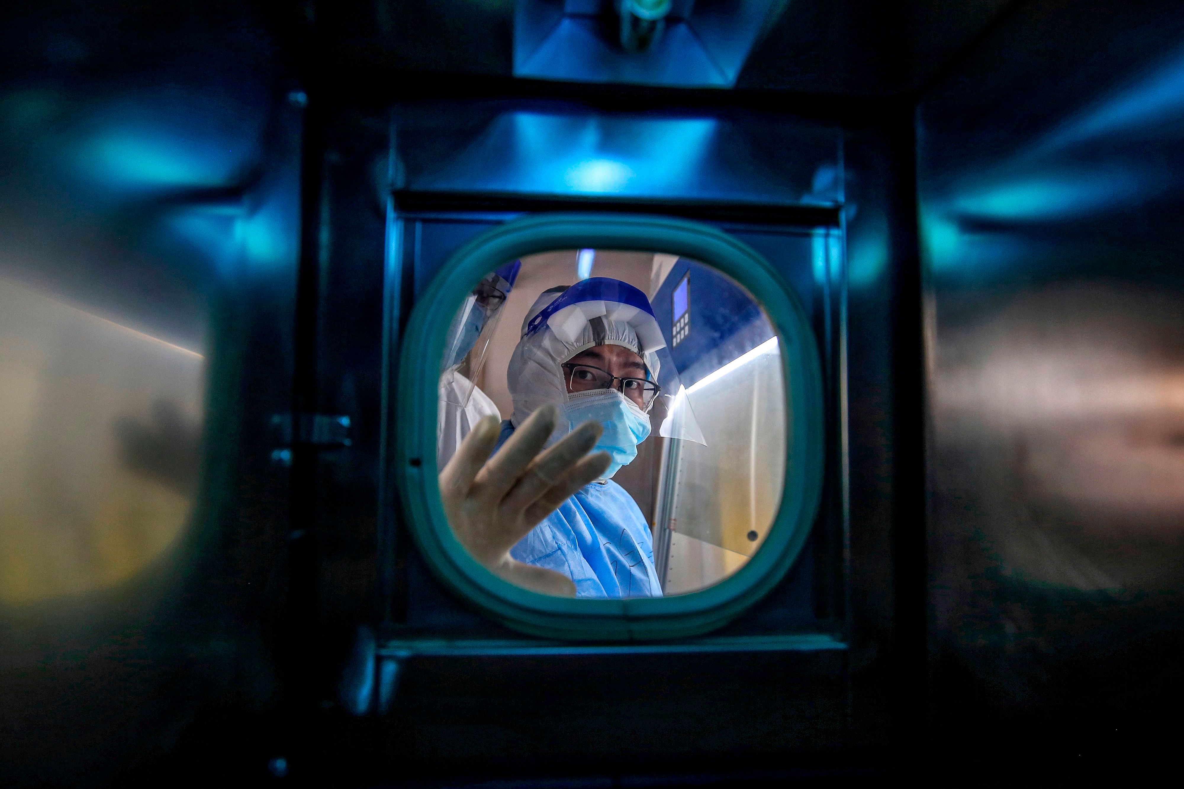 A medical staff member gestures inside an isolation ward at Red Cross Hospital in Wuhan in China's central Hubei province. (Credit: AFP)