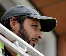 Pakistan captain Shahid Afridi looks out from the pavilion on the 4th day of the first test match against Australia at Lord's cricket ground, London on Friday. AP