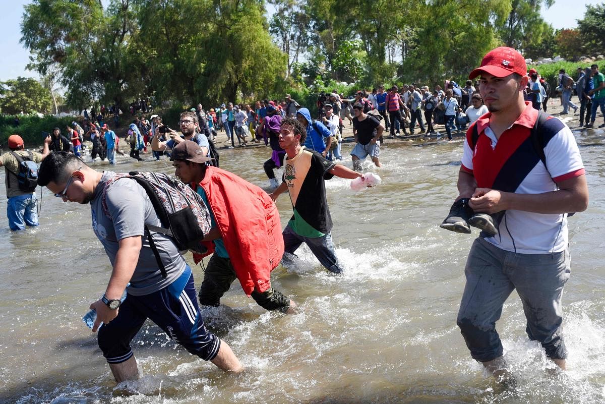 Central American migrants - mostly Hondurans travelling in caravan to the US- cross the Suchiate River, the natural border between , Guatemala, with Ciudad Hidalgo, Mexico. (AFP Photo)